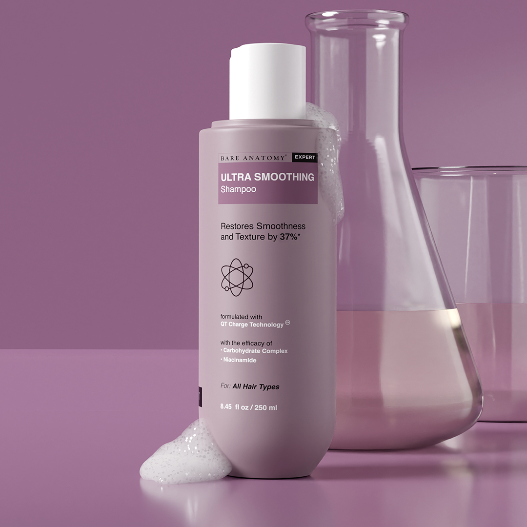 A bottle of Ultra Smoothing Shampoo showcasing hair care innovation and hydration.