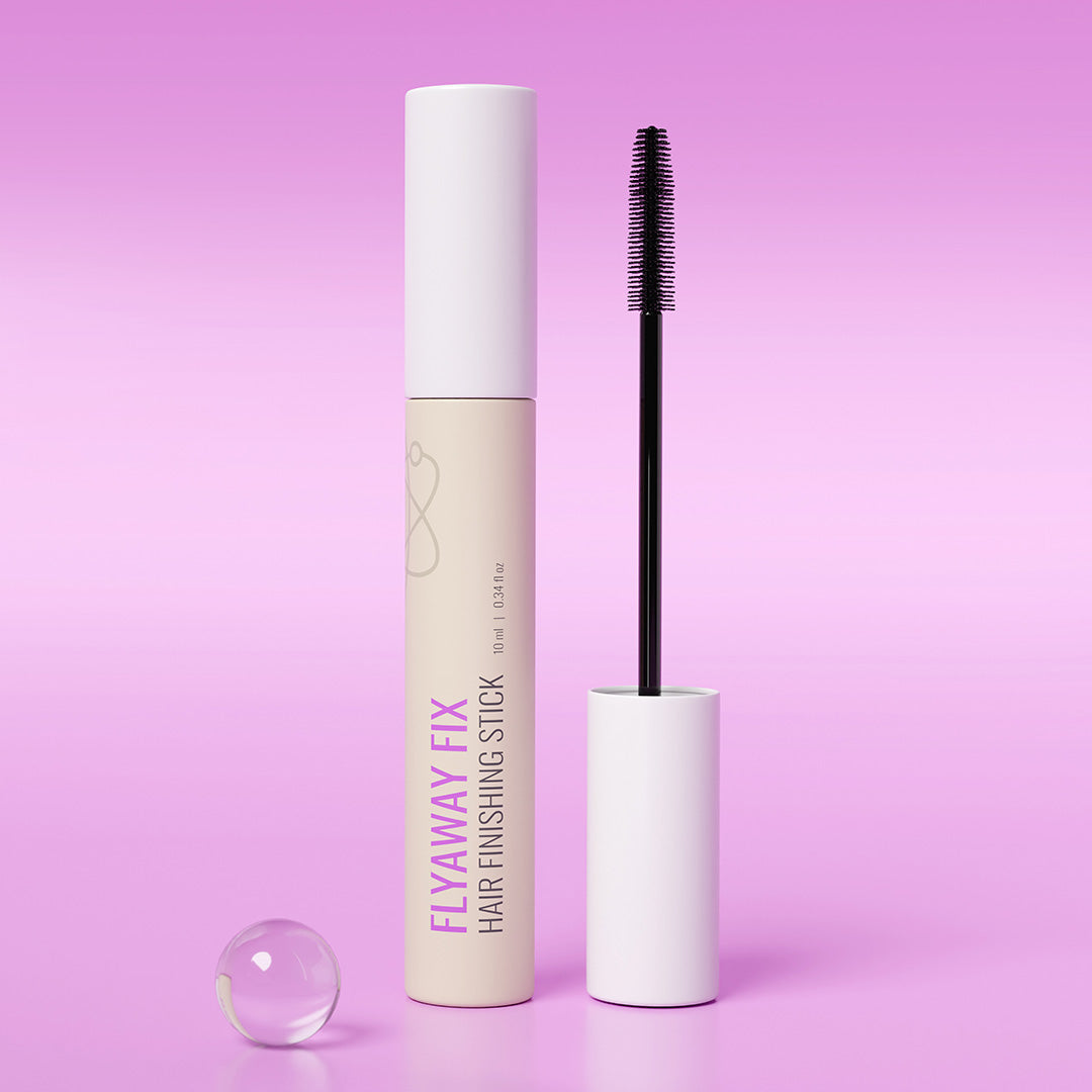 Hair finishing stick with applicator on a pink background