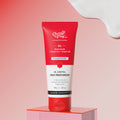 Red tube of Chemist & Co. oil control face moisturizer on a pink platform with a pink gradient background.